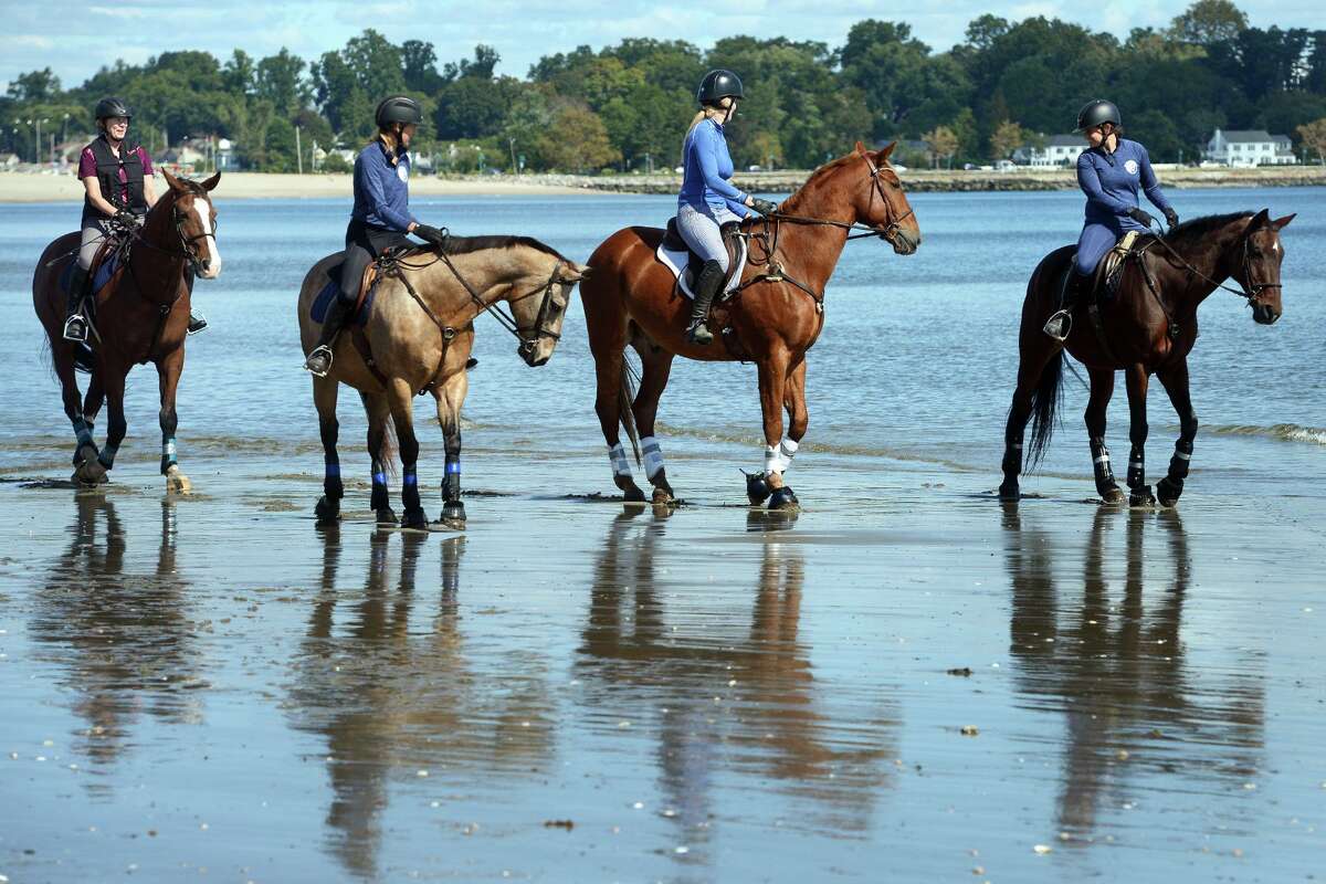 A group of women ride on horseback at Penfield Beach, in Fairfield, Conn. Oct. 1, 2021.