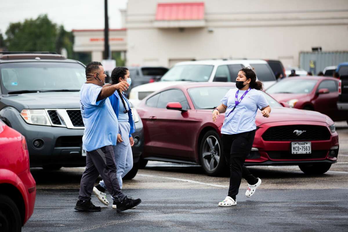 Yes Prep Southwest Secondary school student Kimberly Mendez, 14, rushes to embrace her father Rudis Mendez, 41, at a parking lot on the corner of Hiram Clarke Rd. and W. Fuqua St. after a shooting took place at her school, Friday, Oct. 1, 2021, in Houston.