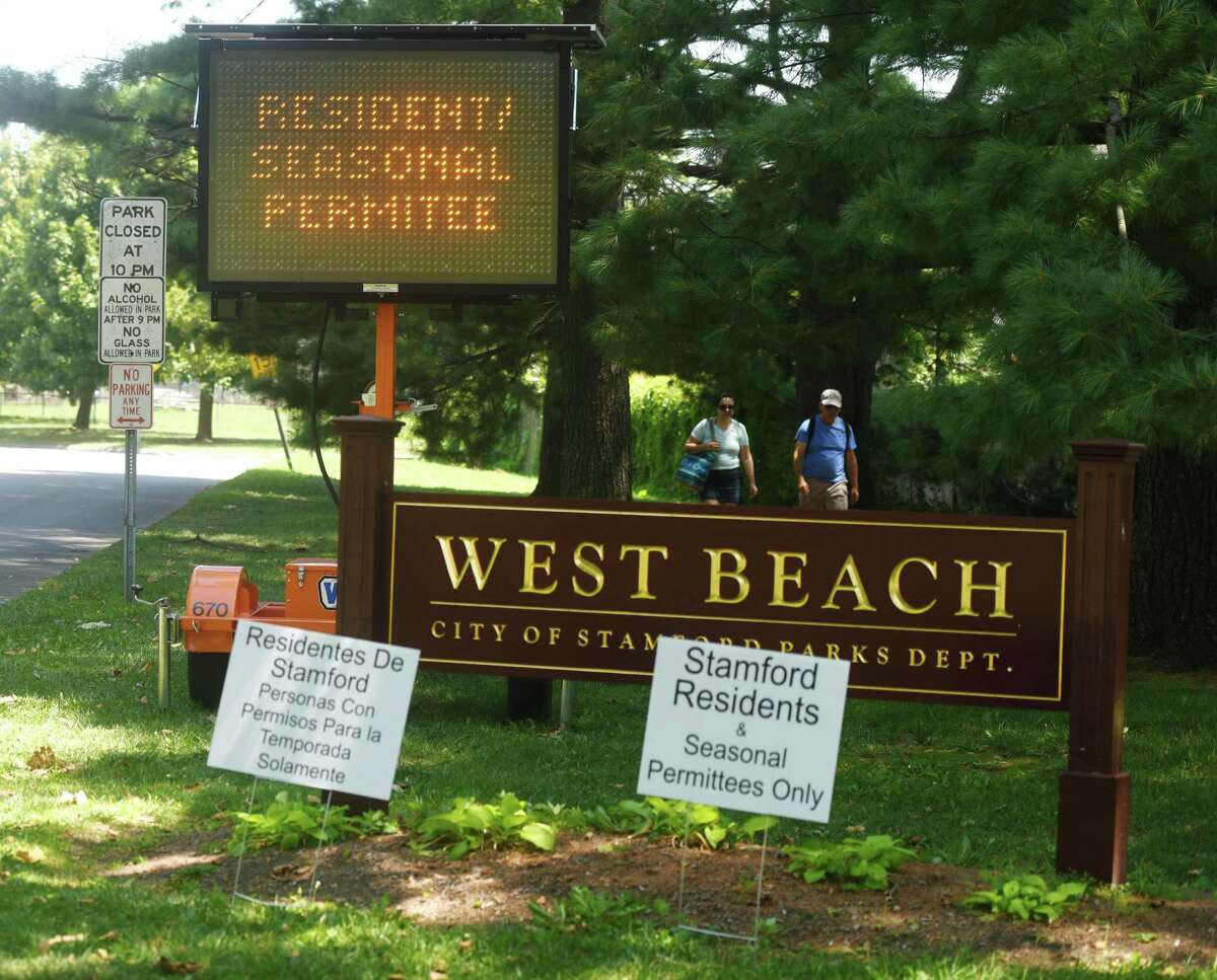 A sign notifies beachgoers that park permits are required at West Beach. The city’s Parks and Rec committee is recommending eliminating the permits by 2023 to city residents with cars registered in Stamford and make up the drop in income with higher taxes.