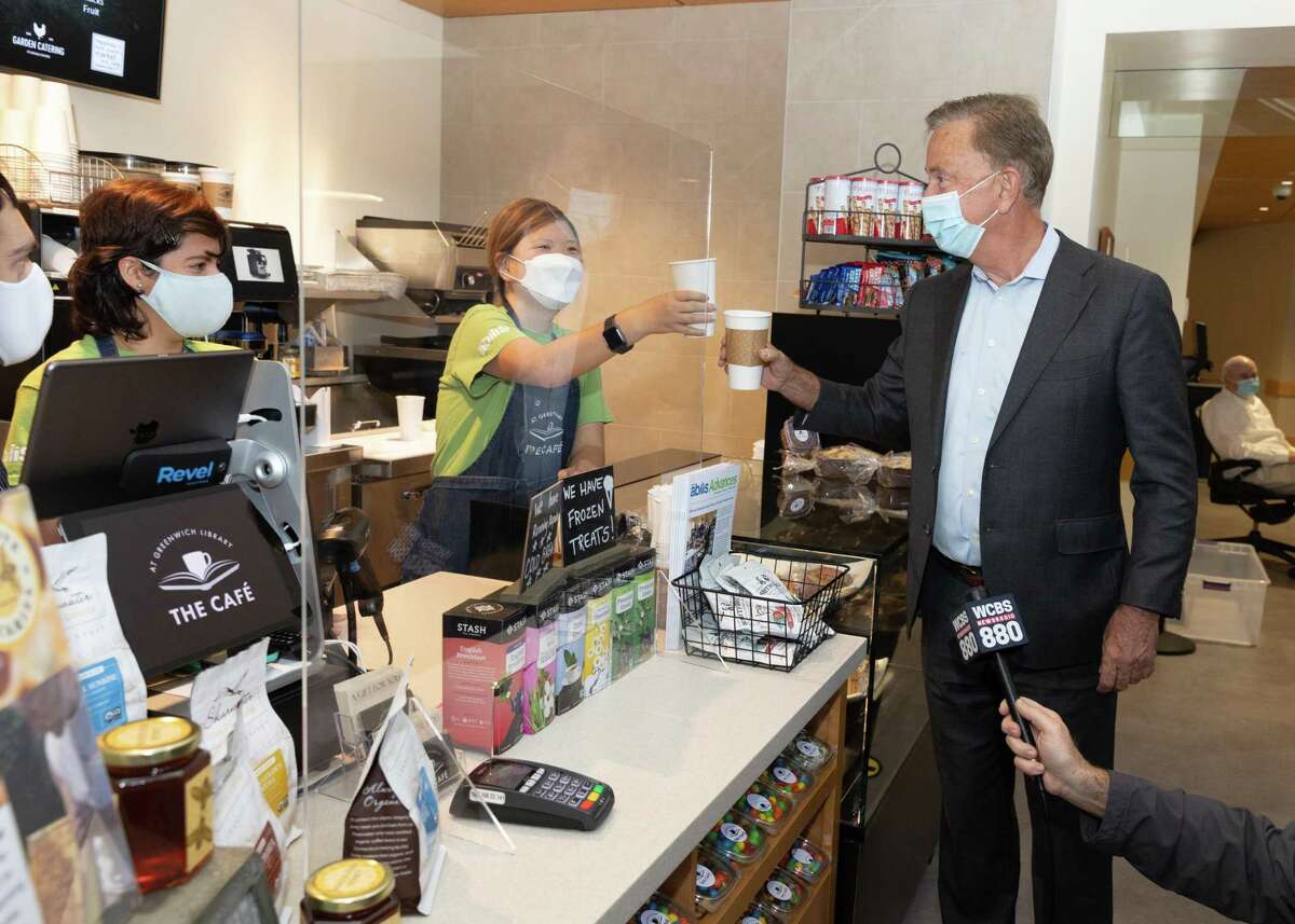 When Gov. Ned Lamont stopped by The Café at Greenwich Library on Friday, Oct. 1, 2021, he made sure to buy a hot raspberry tea and share a toast with café employee Michelle Yoon as Desiree Pizzuco looks on.