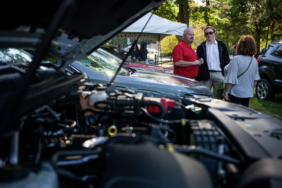 Visitors check out over 500 vehicles from 65 manufacturers during the 58th Northwood University International Auto Show Friday, Oct. 1, 2021 at Northwood University in Midland. (Katy Kildee/kkildee@mdn.net)