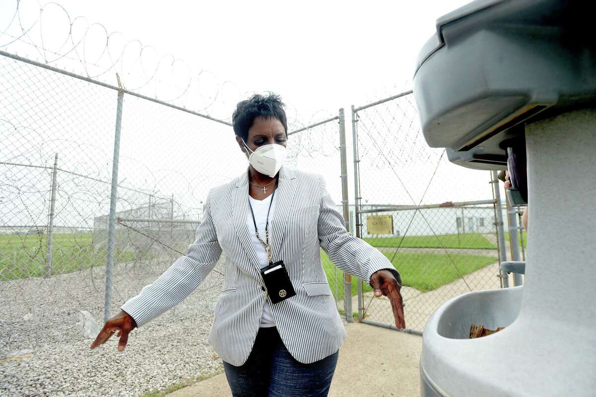 Sheriff Zena Stephens washes her hands outside the main entry inside the Jefferson County Jail. A sanitizing station is placed outside the gate for employees to use upon entering or exiting the unit. It is one of several that are situated throughout the grounds and inside dorms and common areas at the correctional facility, where about 60 of the nearly 700 inmates and more than a dozen employees have tested positive for COVID-19 recently. Empty dorms are being prepared to be used as shelter for those who are positive, and mass testing is underway for those housed at the site. Photo taken Tuesday, July 7, 2020 Kim Brent/The Enterprise