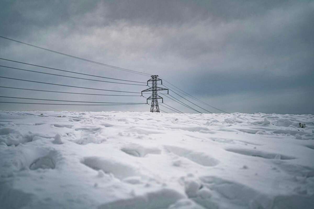 Power lines stretch across the horizon in Dallas on Thursday, Feb. 18, 2021, where amid widespread power losses, millions of Texans, including Houston residents, were advised to boil their water for safety.