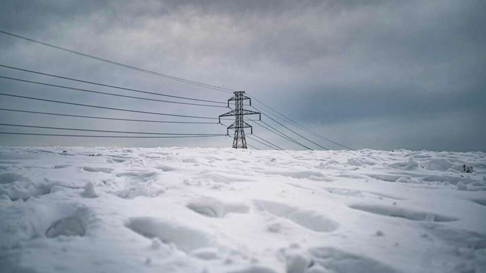 Power lines stretch across the horizon in Dallas on Thursday, Feb. 18, 2021, where amid widespread power losses, millions of Texans, including Houston residents, were advised to boil their water for safety.