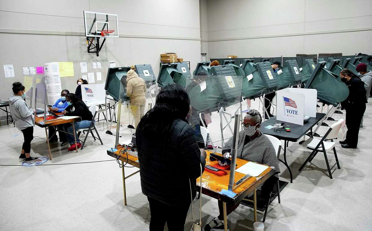 FILE - Voters cast their ballots for the general election at Victory Houston polling station, one of Harris County's 24-hour locations, in Houston, on Friday, Oct. 30, 2020.