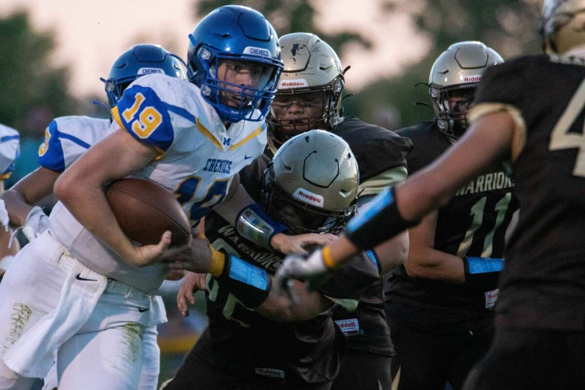 Midland's Drew Barrie stiff-arms a defender during the Chemics' game against Bay City Western Friday, Oct. 1, at Bay City Western High School. (Drew Travis/for the Daily News)