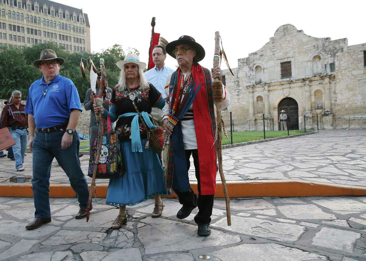 Ramon Vasquez y Sanchez (right) and his wife, Maria Chavez Vasquez, walk with State Rep. Leo Pacheco (left) and State Sen. Jose Menendez in a procession as a local Native American group honored buried descendants during their annual Sunrise Ceremony at the Alamo on Saturday, Sept. 7, 2019. In the past, the group was allowed to have the service inside the Alamo Church. But they were told days before the event that the service would not be permitted inside. Tap Pilam has a lawsuit pending to secure access to the mission-era church for its ceremony and to be included in decision regarding handling of unearthed human remains.