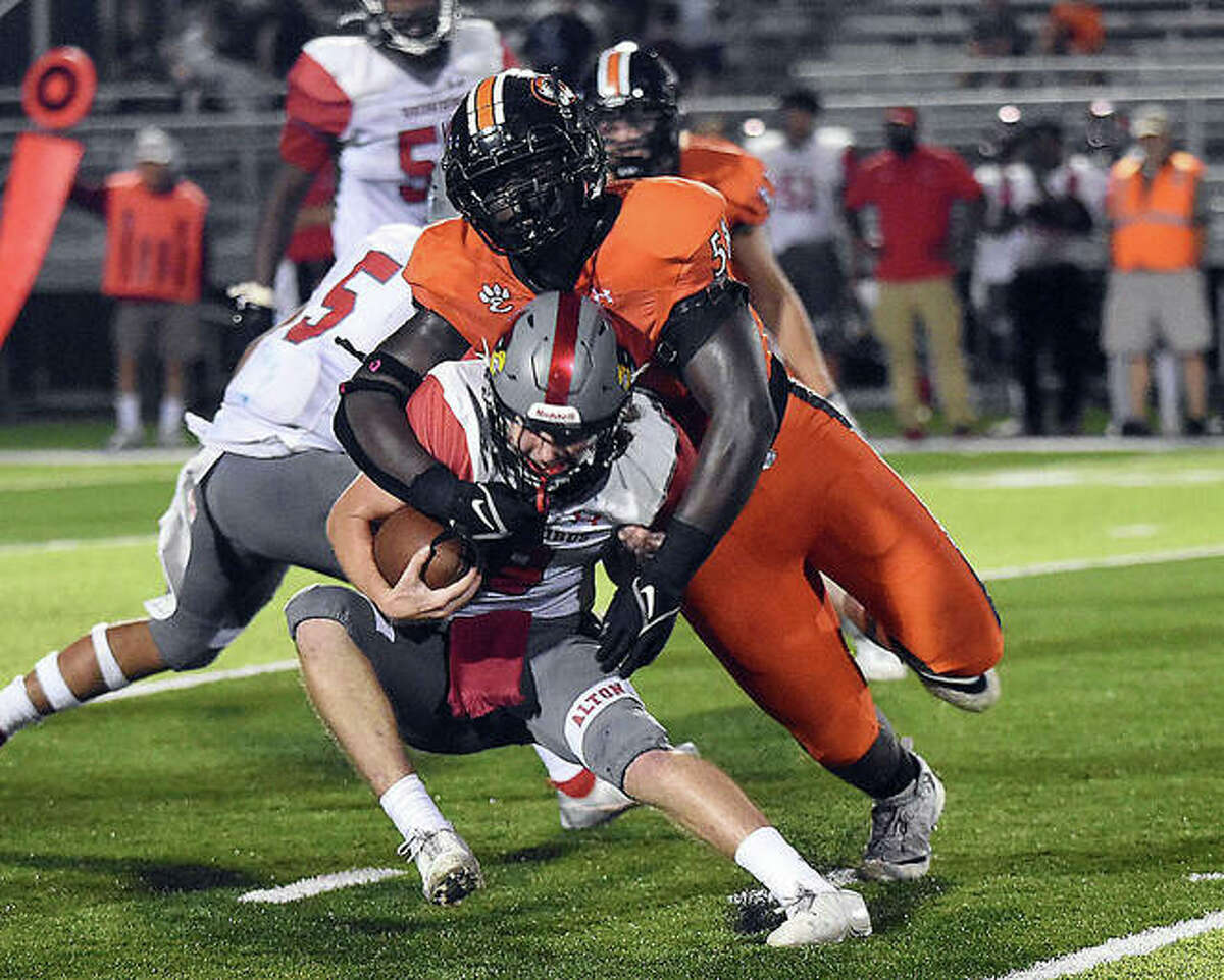 Edwardsville defensive tackle Nasim Cairo gets a sack during the second quarter on Friday in Edwardsville.