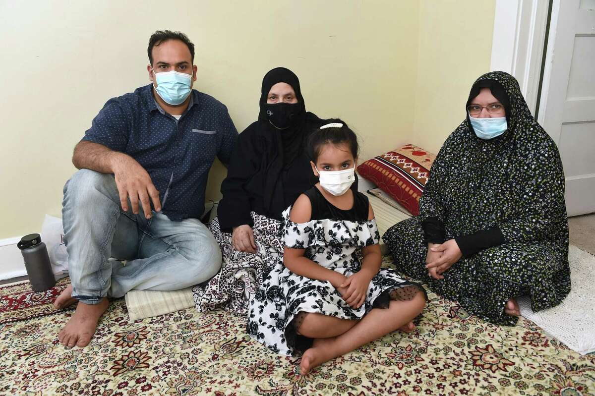 From left, Issa is photographed with his mother, Shaha, daughter, Retaj, 7, and sister Hameeda, in New Haven on Sept. 13, 2021.