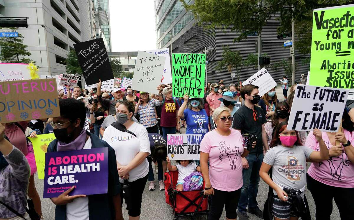 People participating in the Houston Women's March against Texas abortion ban walk along Walker from Discovery Green to City Hall Saturday, Oct. 2, 2021 in Houston.
