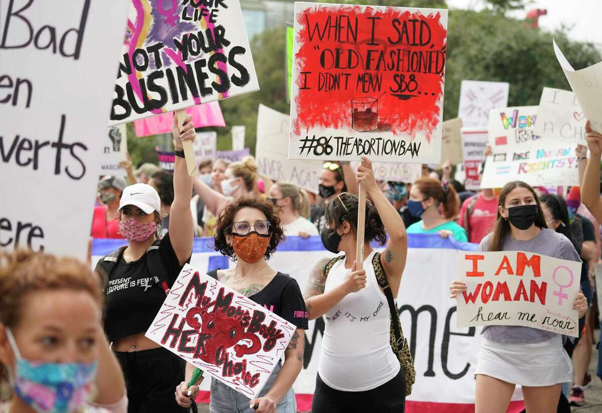 People participating in the Houston Women's March against Texas abortion ban walk from Discovery Green to City Hall Saturday, Oct. 2, 2021 in Houston.