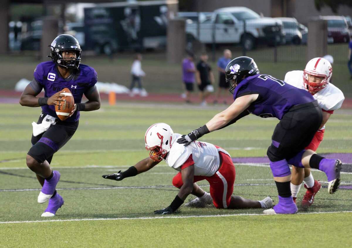 Willis quarterback Derek Lagway (2) looks for an opening to pass the ball while being protected by offensive lineman Ford Ivey (75) against Bellaire Ejike Brown (4) during the second quarter of a non-district football game at Berton A. Yates Stadium, Friday, Sept. 10, 2021 in Willis.