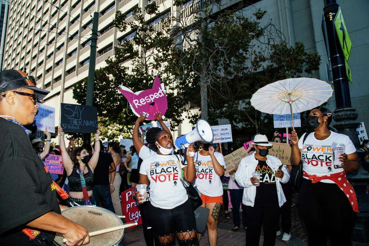 Protesters sing during the reproductive rights march in San Francisco.