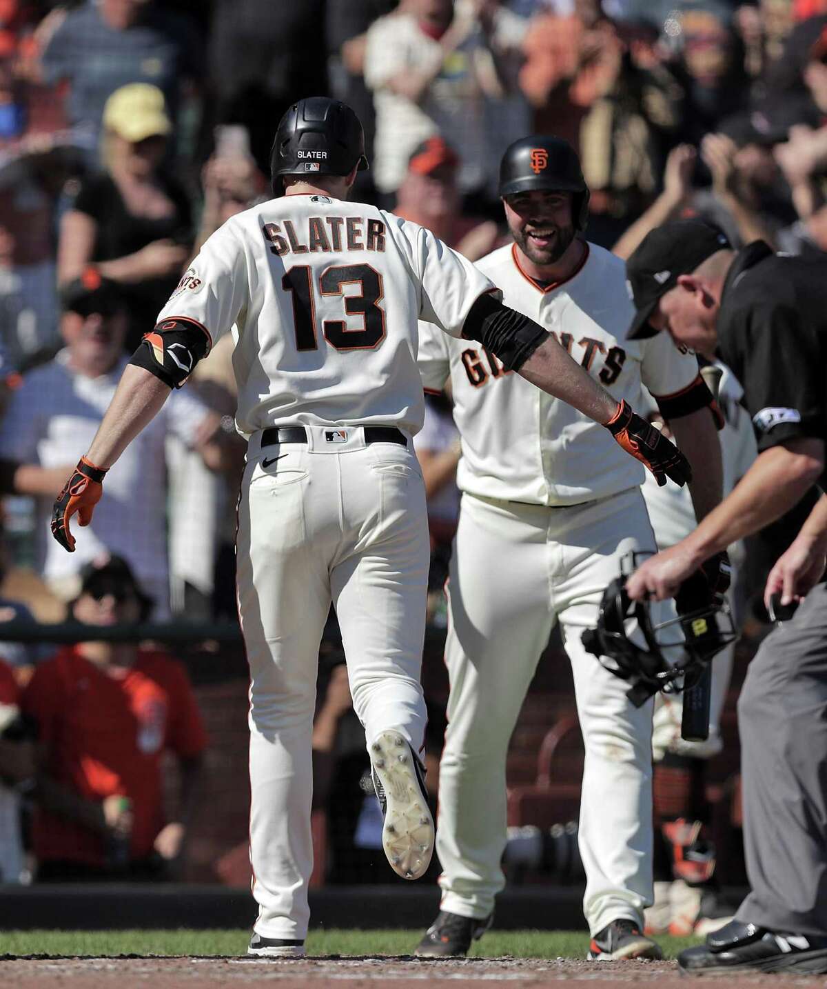 Austin Slater (13) scores on his solo homerun in the sixrth inning as the San Francisco Giants played the San Diego Padres at Oracle Park in San Francisco, Calif., on Saturday, October 2, 2021.