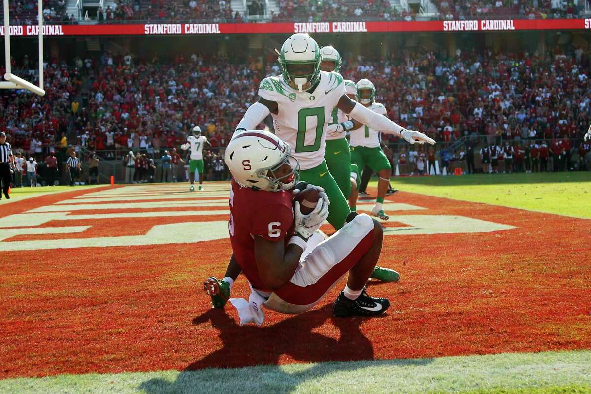 CORRECTS ID TO ELIJAH HIGGINS NOT JAYLON REDD - Stanford's Elijah Higgins catches a touchdown against Oregons' DJ James (0) during the second half of an NCAA college football game in Stanford, Calif., Saturday, Oct. 2, 2021. (AP Photo/Jed Jacobsohn)