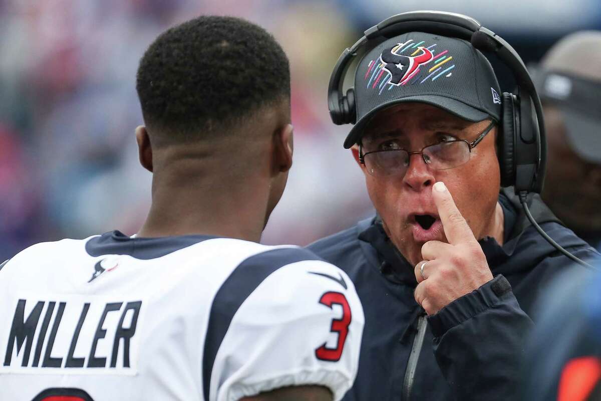 Houston Texans head coach David Culley talks to wide receiver Anthony Miller (3) during the first half of an NFL football game Sunday, Oct. 3, 2021, in Orchard Park, N.Y..