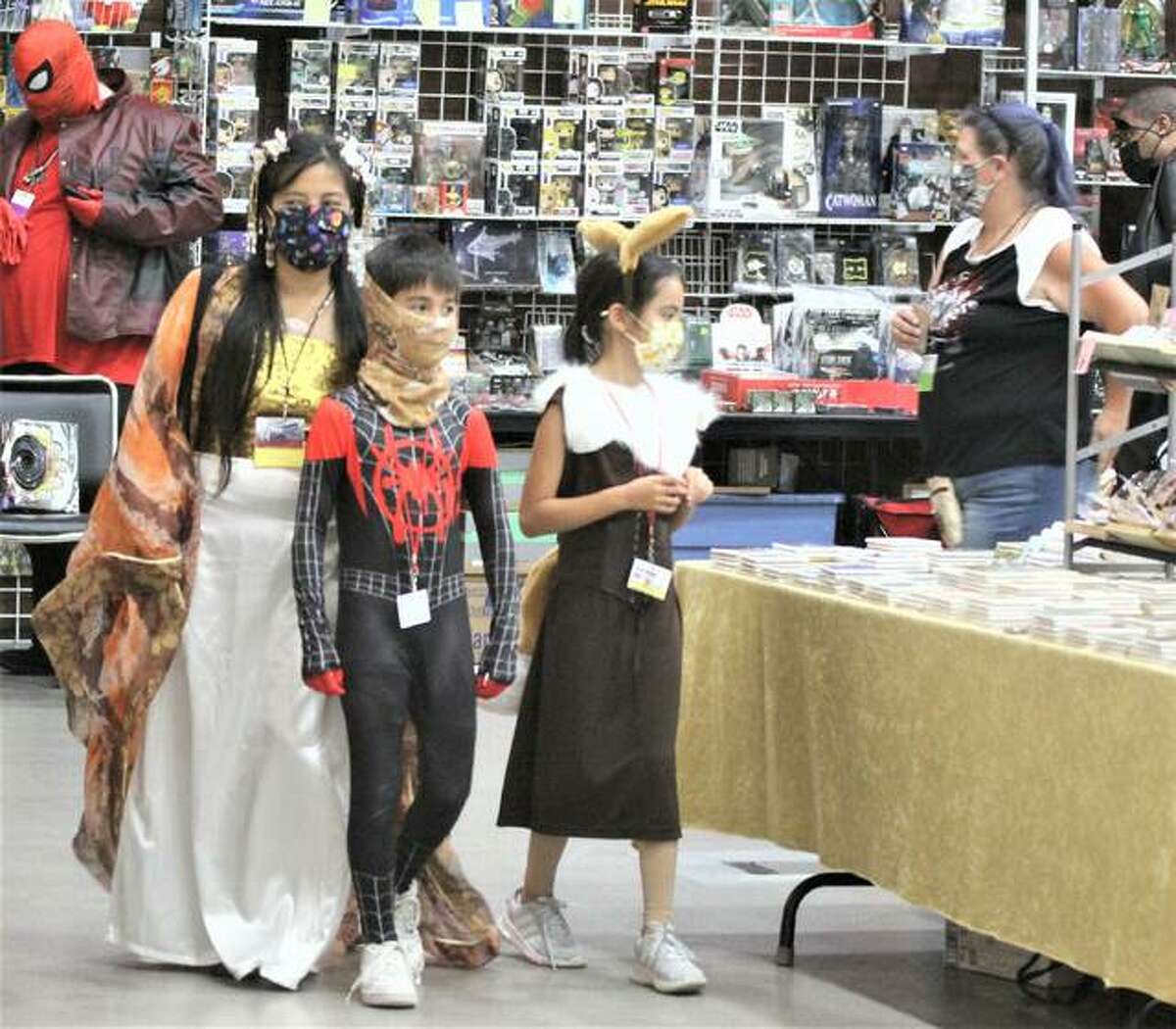 Jeannie Lin, a St. Louis author specializing in historical romance and historical fantasy, and her twin children, Daniel and Mae Linh, look at merchandise in the dealer’s room at Archon, the region’s premier Sci-Fi/Fantasy convention, held Oct. 1-3 in Collinsville’s Gateway Convention Center. After missing last year because of COVID, the convention, or “Con,” came back, but somewhat subdued and about half the normal attendance.