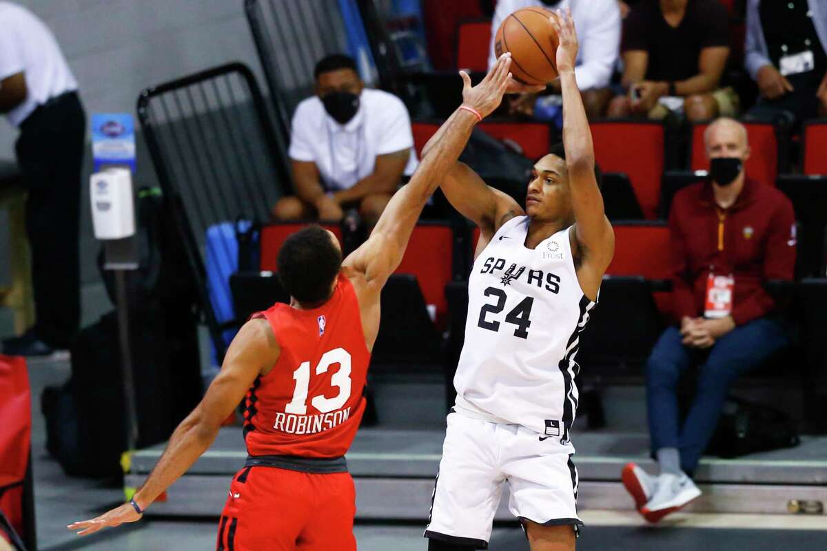 San Antonio Spurs' Devin Vassell (24) shoots as Chicago Bulls' Jerome Robinson (13) defends during the first half of an NBA summer league basketball game in Las Vegas on Tuesday, Aug. 10, 2021. (AP Photo/Chase Stevens)