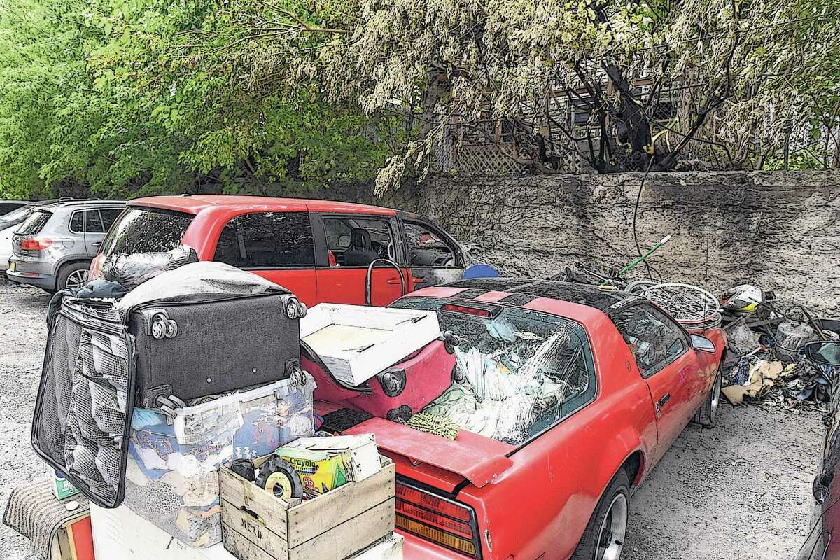 Abandoned cars and trash are part of the landscape in an alleyway off Knox Street between Myrtle Ave. and Morris Street on Thursday, Sept. 23, 2021, in Albany, N.Y. The area also serves as a parking space for nearby apartments. (Will Waldron/Times Union)