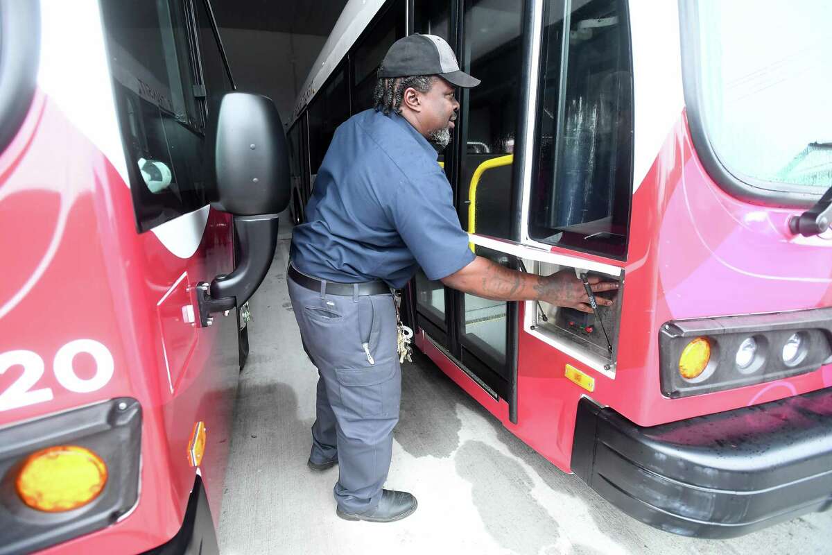 Port Arthur Transit maintenance supervisor Anthony Grogan powers up one of the buses in its growing fleet of zero emission all electric buses. Photo made Friday, October 1, 2021 Kim Brent/The Enterprise
