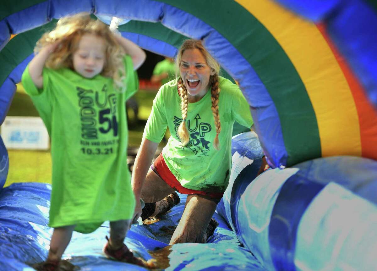 Hannah Bible, of Greenwich, cheers on her daughter, Alicebella Bible, 2, as they tackle the final obstacle.