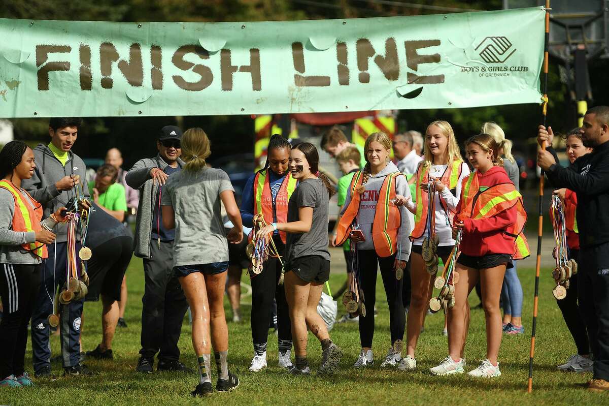 Runners cross the finish line on Sunday.