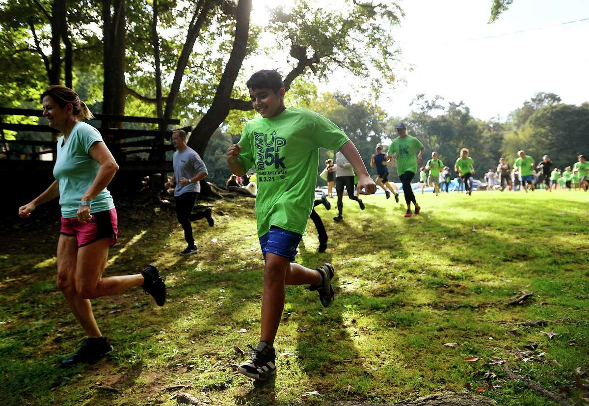 Runners head out from the start of the 9th Annual Muddy Up 5k run put on by the Boys and Girls Club of Greenwich at Camp Simmons in Greenwich, Conn. on Sunday, October 3, 20i21.