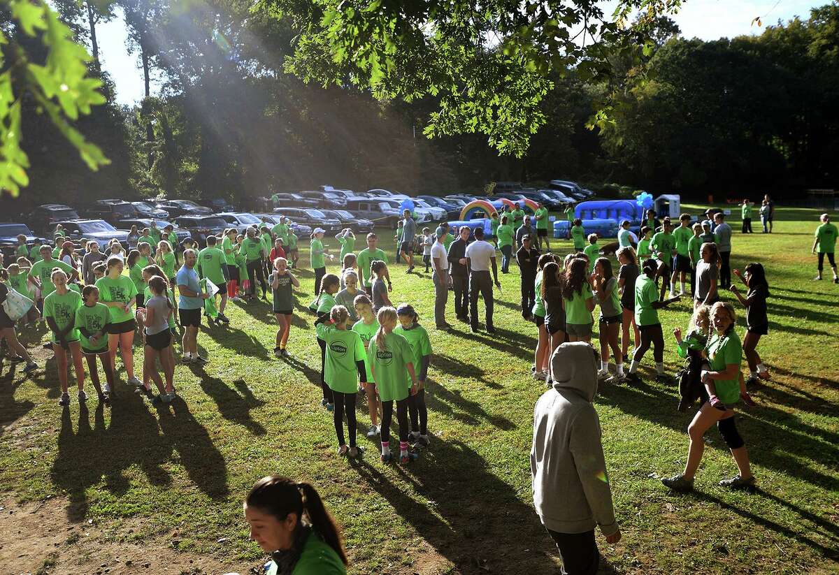 Runners gather for the start of the 9th Annual Muddy Up 5k run put on by the Boys and Girls Club of Greenwich at Camp Simmons in Greenwich, Conn. on Sunday, October 3, 20i21.