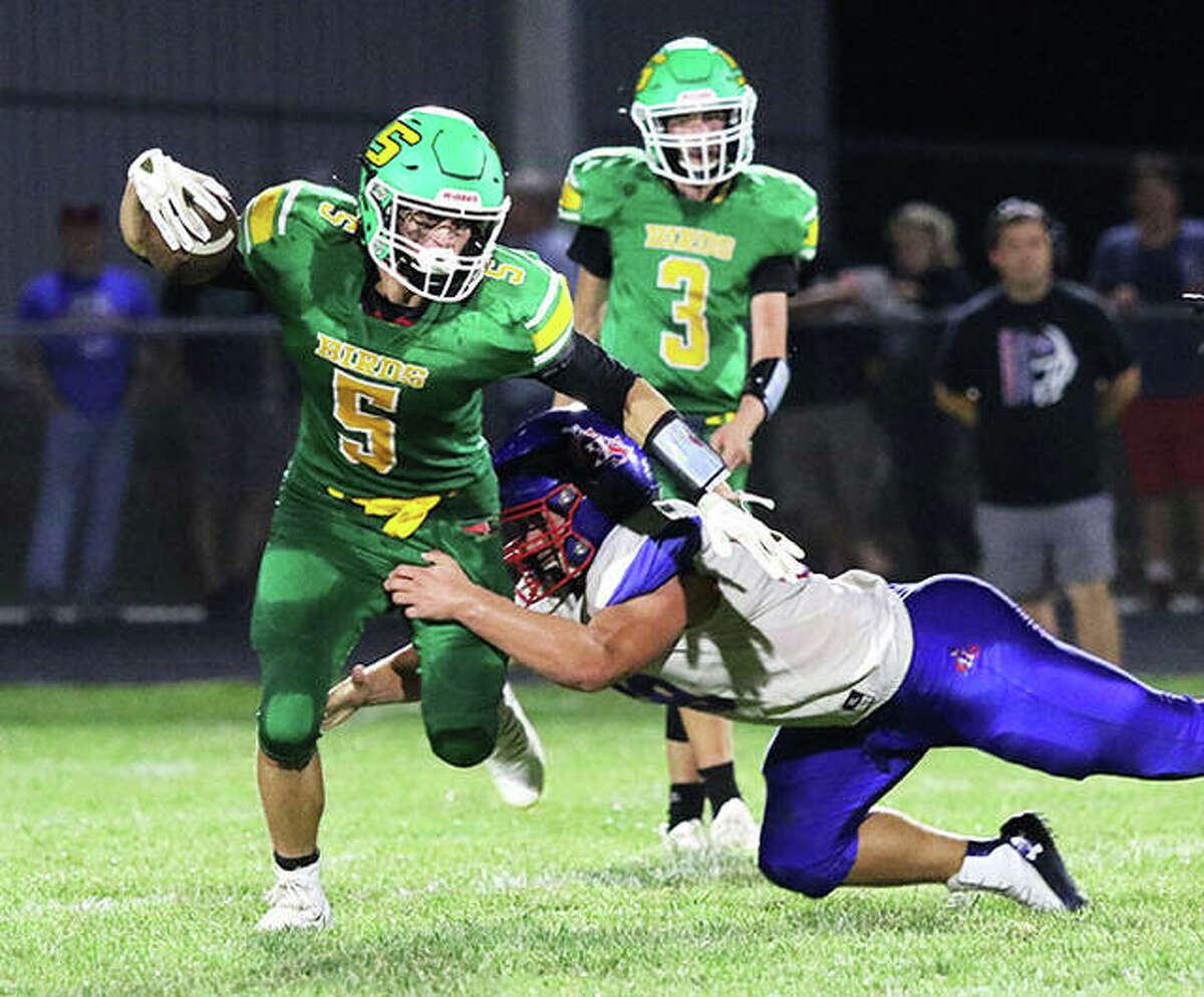 Southwestern’s Gavin Day (5) is hit by Carlinville’s Colton Robinson in the first half of their SCC football game Friday night at Knapp Field in Piasa.