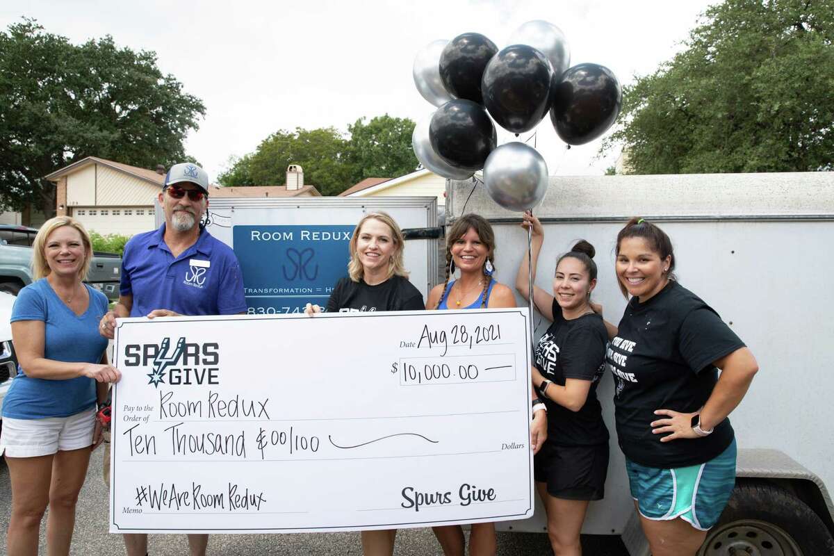 From left, Room Redux and Spurs Give representatives Beverly Davidek, Greg Vybiral, Angela Sparks, Susie Vybiral, Lorraine Benavides and Amanda Fite celebrate a $10,000 donation in August.