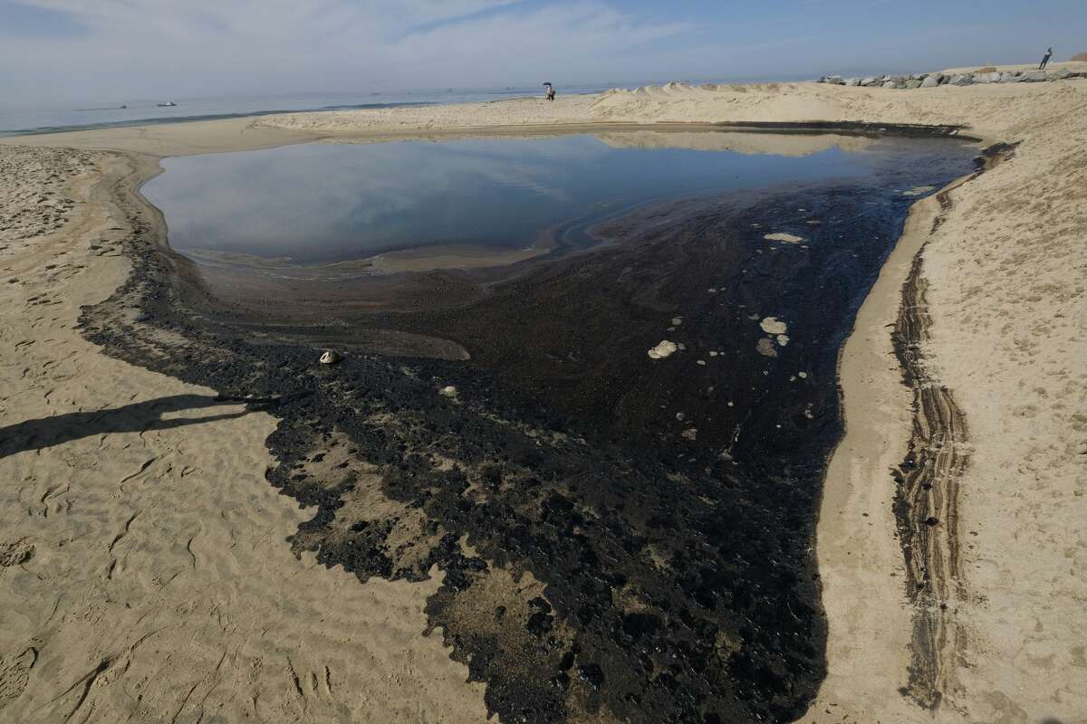 Oil washes up on Huntington Beach, Calif., Sunday, Oct. 3, 2021.