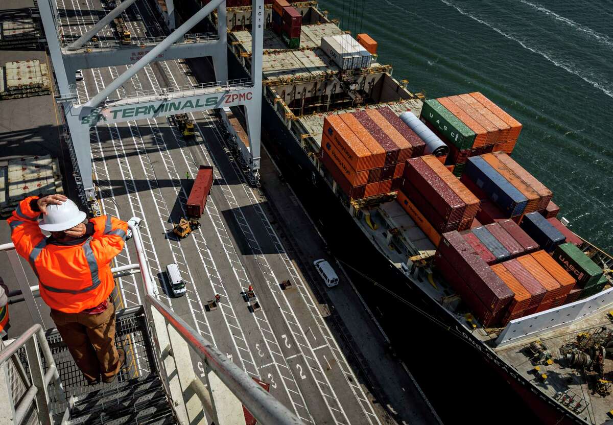 The Long Beach Express cargo ship has its cargo offloaded at the SSA Terminal in the Port of Oakland. Ports in the Bay Area aren’t backed up, but there are major delays at other California ports.