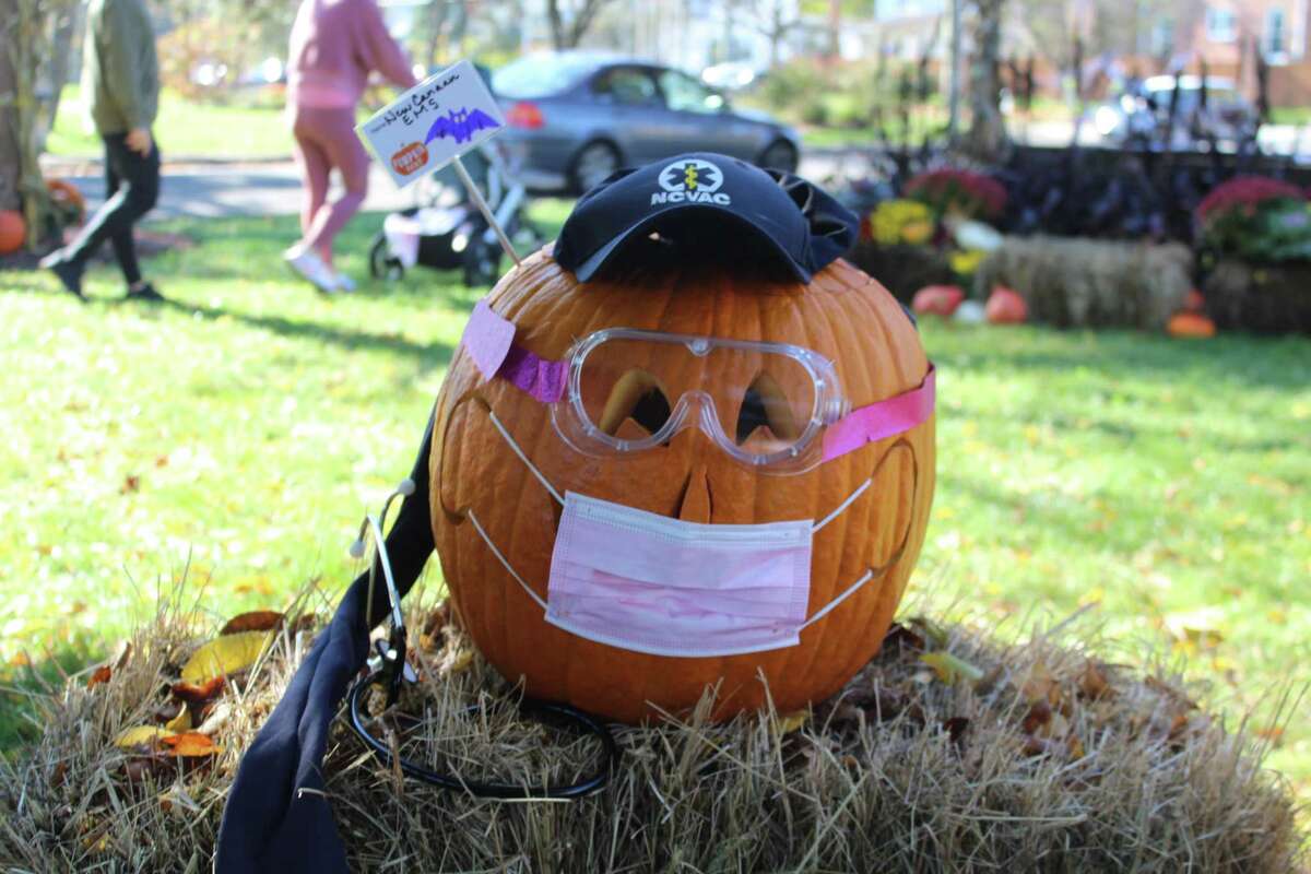 The New Canaan EMS pumpkin at Pumpkin Fest donned a mask and goggles, the protective gear needed on this Halloween during the COVID-19 pandemic.