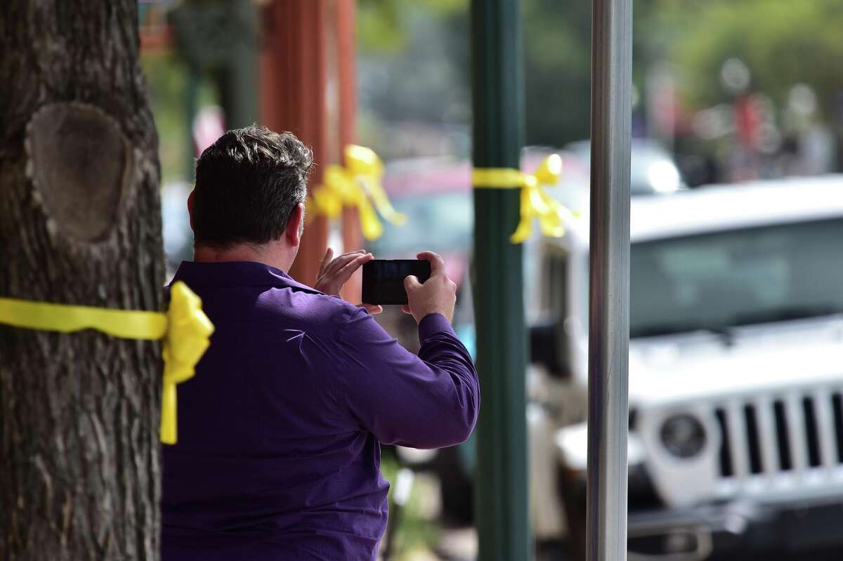 Residents cover Boerne’s Main Street in yellow ribbons as a reminder of