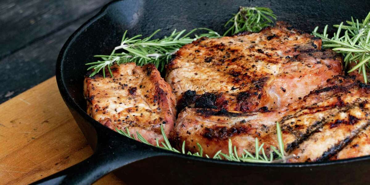 A sprig of rosemary adds a pop of flavor to grilled porkchops.