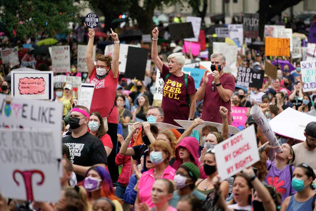 People participating in the Houston Women's March against Texas abortion ban listen to speakers at City Hall Saturday, Oct. 2, 2021 in Houston.
