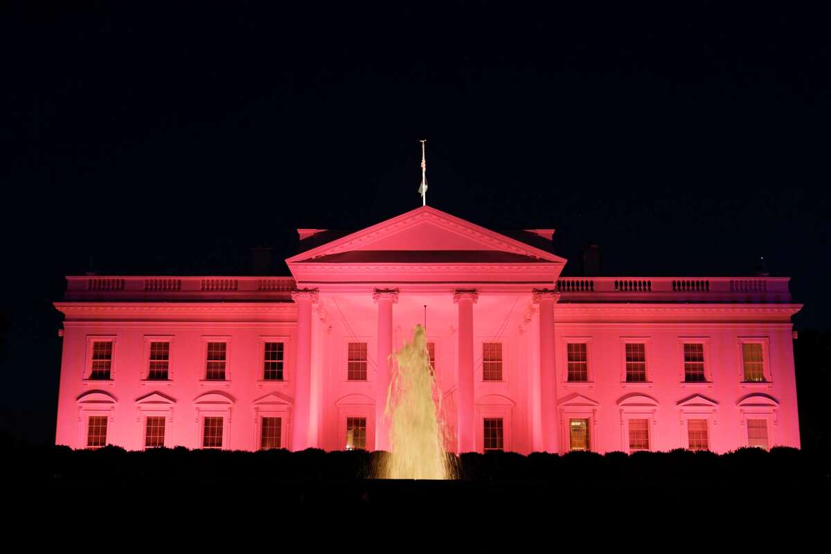 The White House in Washington, Friday, Oct. 1, 2021, is illuminated in pink light in recognition of Breast Cancer Awareness month.