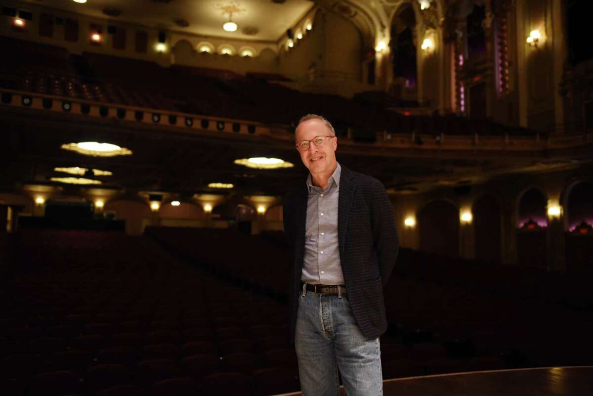 David Alan Miller, conductor and music director of the Albany Symphony Orchestra, stands on the state at the Palace Theatre on Monday, Oct. 4, 2021, in Albany, N.Y.