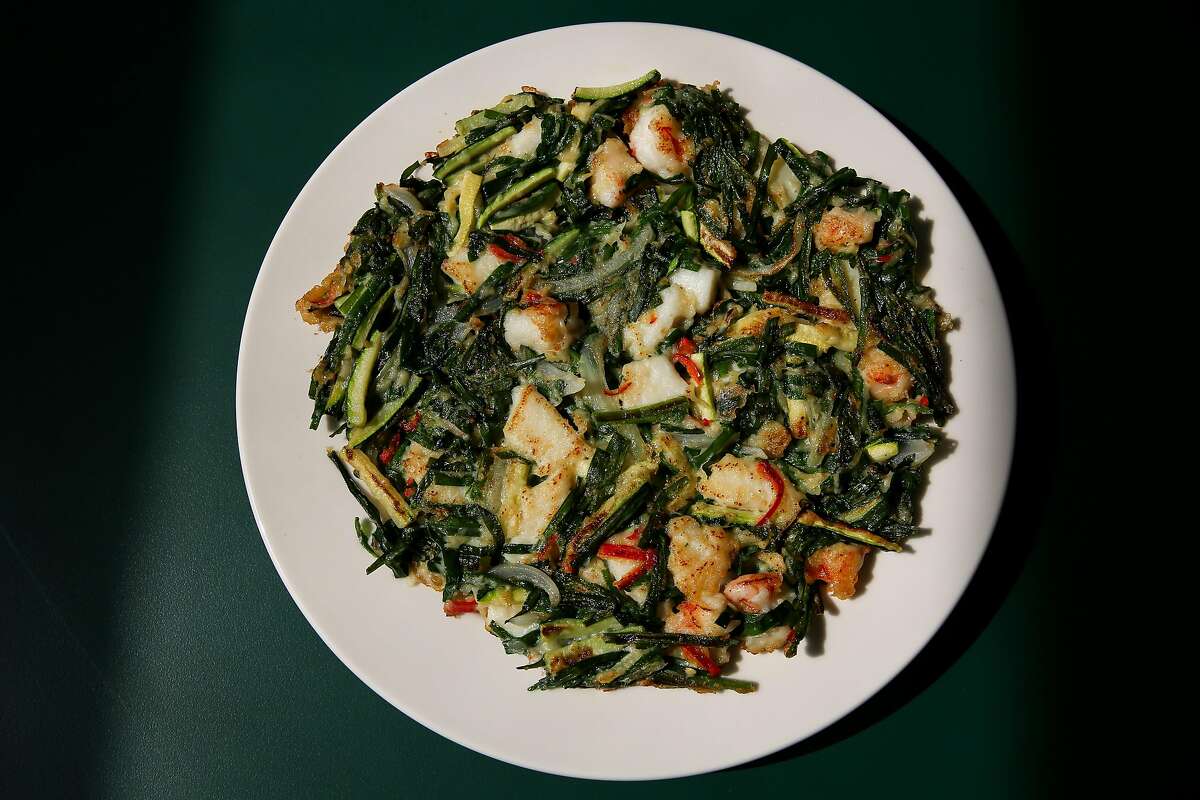 Haemul buchu jeon, a savory pancake with shrimp, squid, garlic chive and squash, will be on Queens’ new dine-in menu.