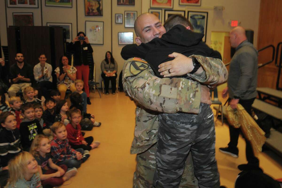 Fifth-grader Joshua Ochoa hugs his father, U.S. Army Staff Sgt. Joshua Ochoa, after a surprise meeting between the father and son during an assembly at Scotland Elementary School, in Ridgefield, Conn. Dec. 10, 2019.