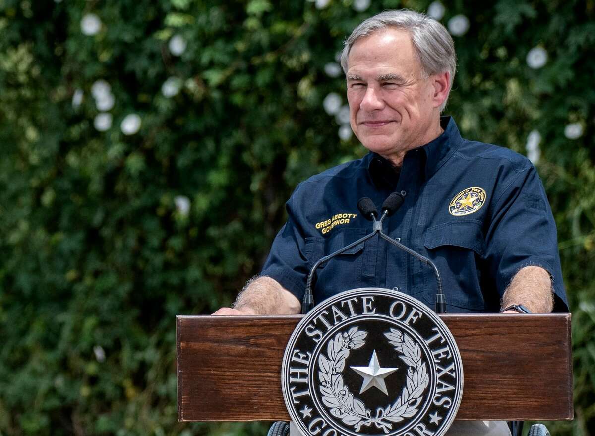 Texas Governor Greg Abbott (R) looks on as former US president Donald Trump speaks during a visit to the border wall near Pharr, Texas on June 30, 2021. - Former President Donald Trump visited the area with Texas Gov. Greg Abbott to address the surge of unauthorized border crossings that they blame on the Biden administration's change in policies. (Photo by Sergio FLORES / AFP) (Photo by SERGIO FLORES/AFP via Getty Images)
