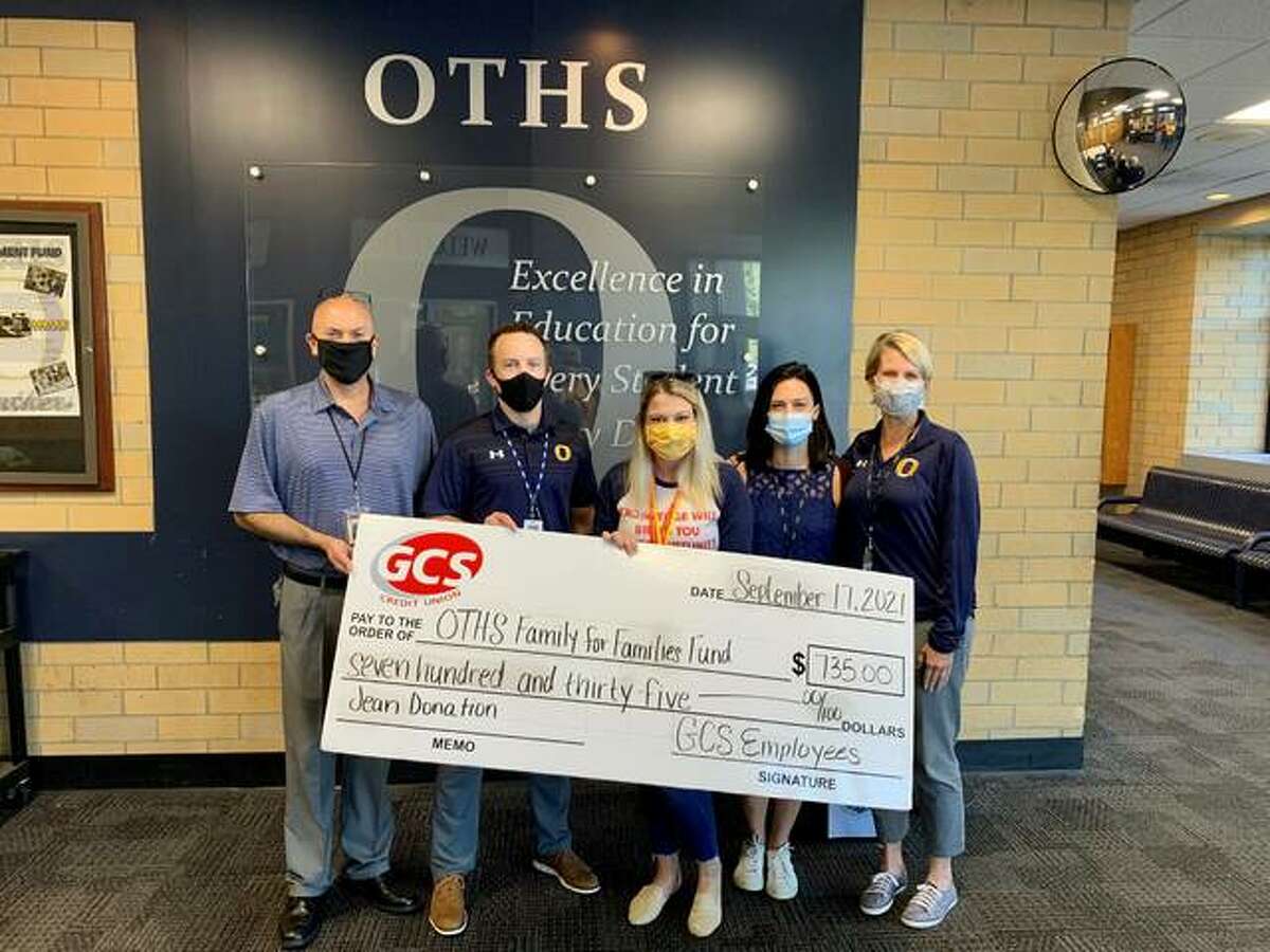 GCS donates an oversized check to the O’Fallon High School Family for Families fund.