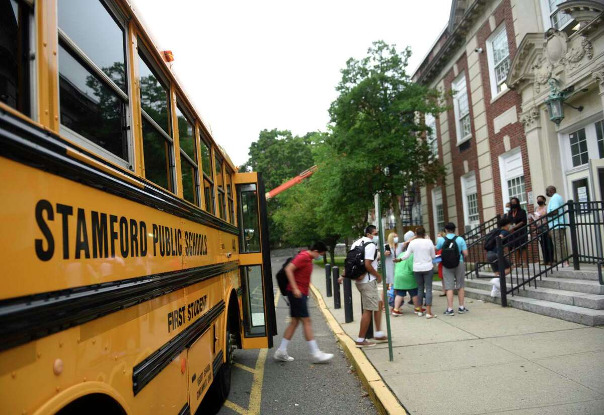 Students enter the first day of school at Stamford High School in Stamford, Conn. Monday, Aug. 30, 2021.