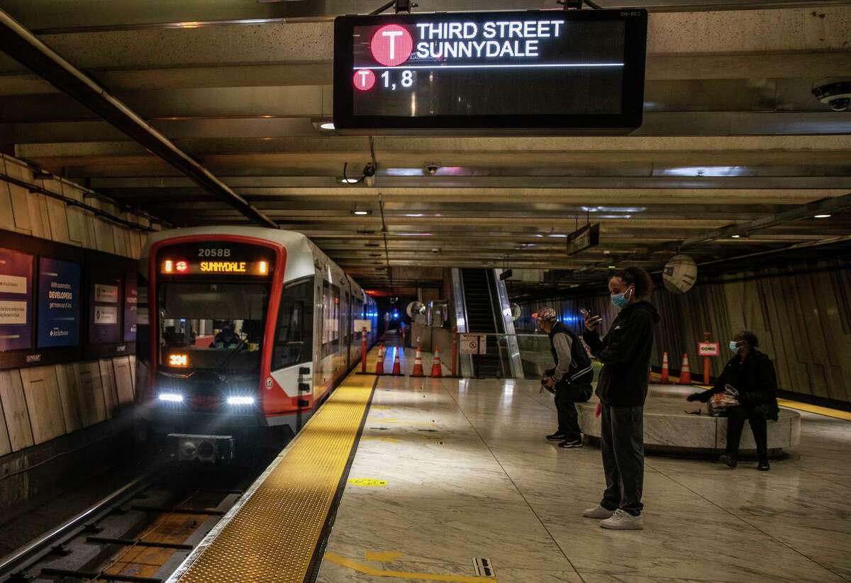 People wait for the MUNI T Third Street train at Embarcadero Station in San Francisco in May. Unvaccinated employees could mean the transit agency will scale back service by Nov 1.