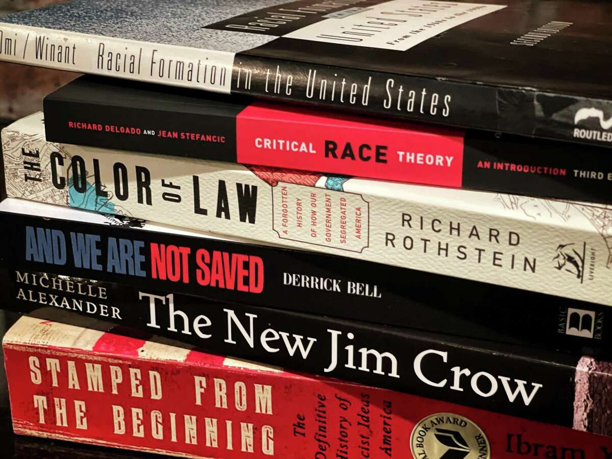 This July 2021 photo shows several of the books commonly assigned in college and law school courses focused on critical race theory. The once-obscure academic discipline has emerged as a flashpoint in political debates, with Republicans in Texas and other states passing legislation to ban the teaching of critical race theory or “CRT” in public schools.