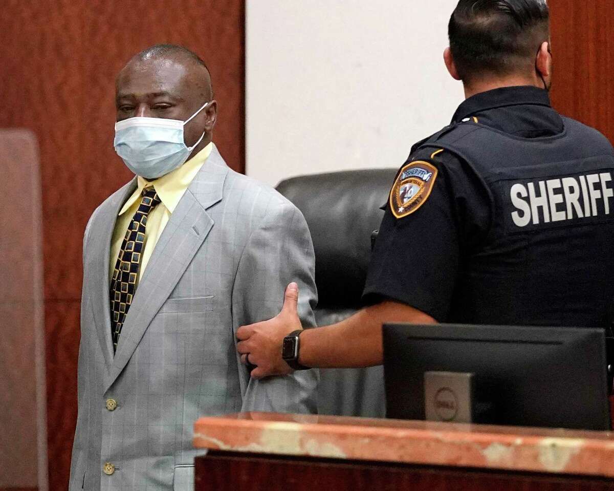 David Conley is escorted into the Harris County Criminal Court of Judge Chuck Silverman during his trial Tuesday, Oct. 5, 2021 in Houston for the murders of eight people. Valerie Jackson, her husband, Dwayne Jackson, and six children Nathaniel, 13, Honesty, 11, Dwayne Jr., 10, Caleb, 9, Trinity, 7, and Jonah, 6, were killed on on Aug. 8, 2015. Prosecutors are not seeking the death penalty.