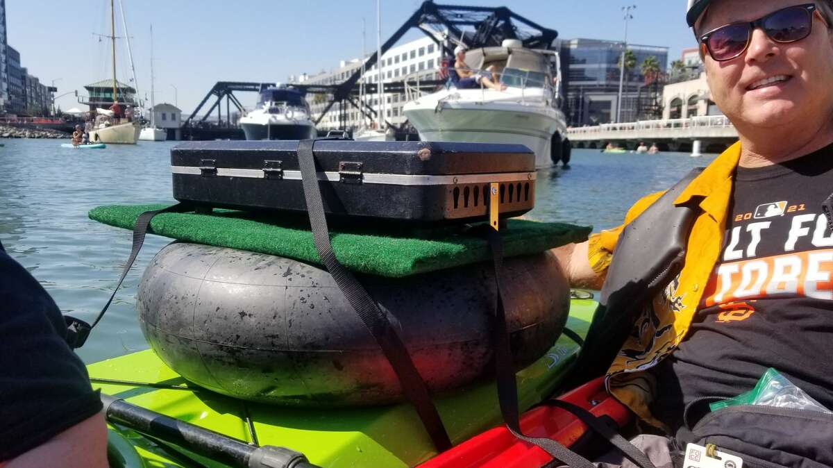 Brian Casey barbecues oysters on his AmphiBBQ during the Sunday San Francisco Giants game in McCovey Cove. 