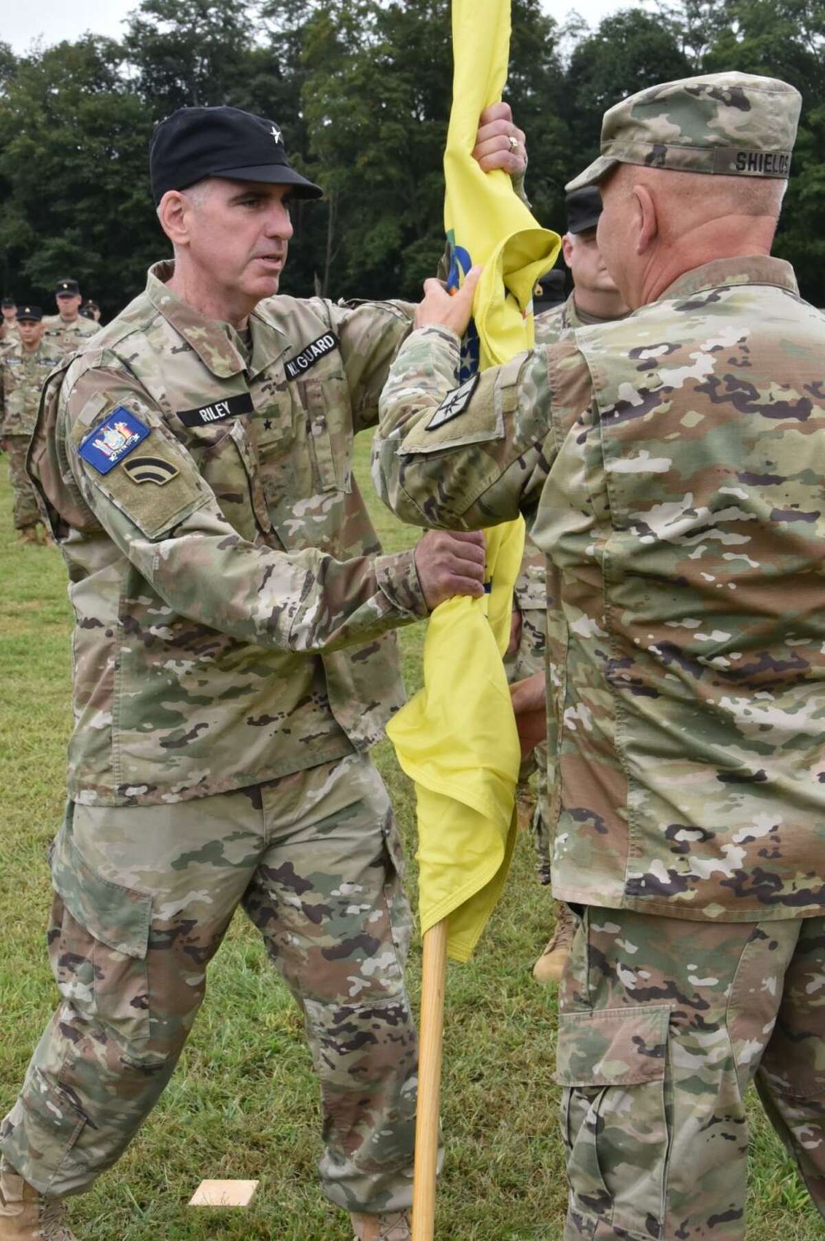  New York Guard Brig. Gen. Peter Riley, left,  accepts the colors of the New York Guard from Maj. Gen. Ray Shields, state adjutant general, during a change of command at Camp Smith Training Site near Peekskill.