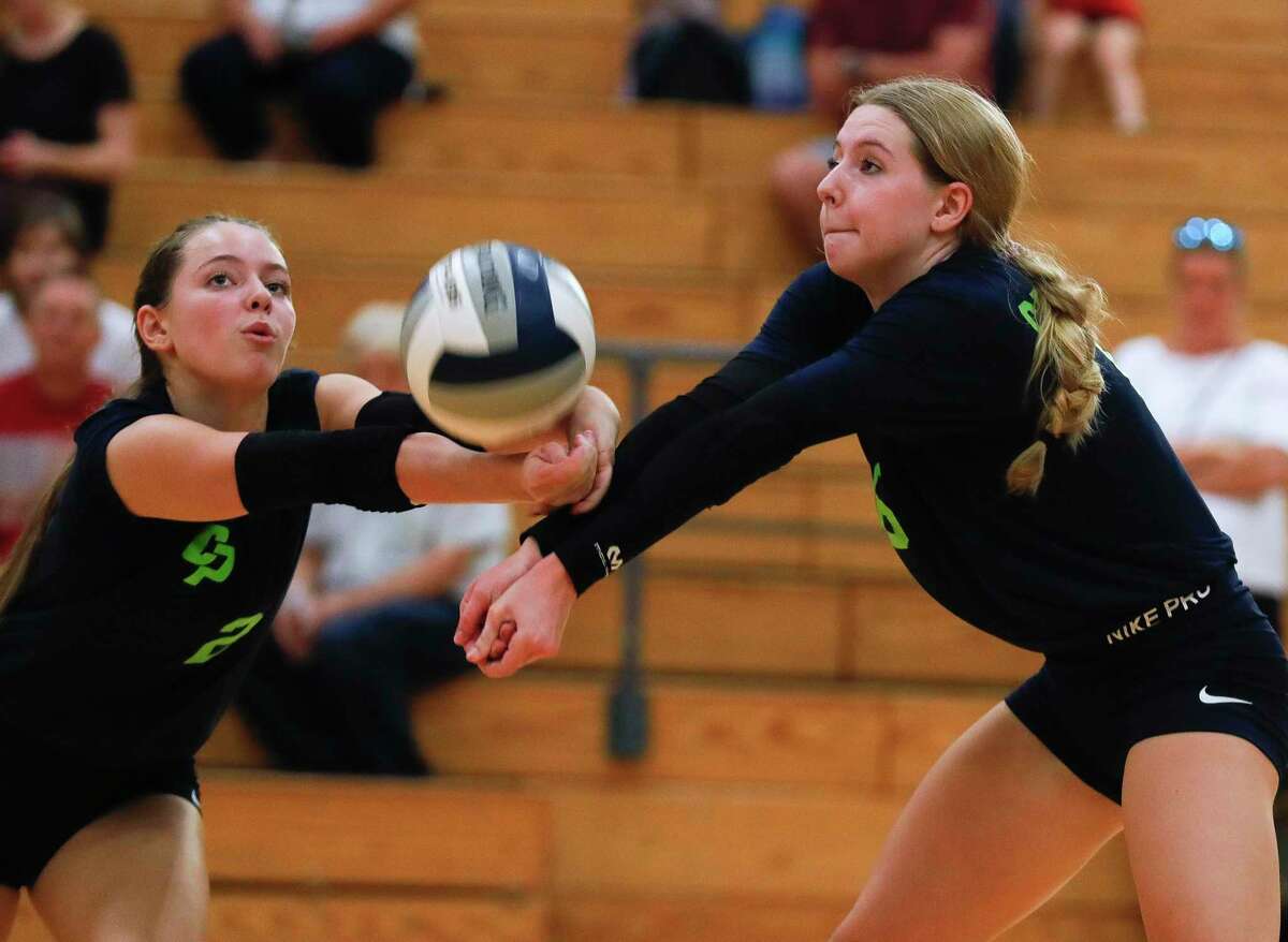 College Park’s Morgan Madison (2) and Mallory Madison (6) collide while returning a hit during the first set of a high school volleyball match at The Woodlands High School, Tuesday, Oct. 5, 2021, in The Woodlands.