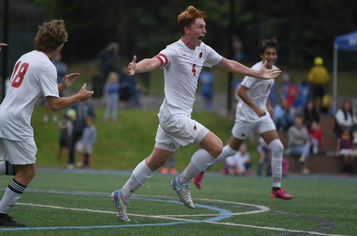 Greenwich’s Jake Hugh-Jones (4) celebrates after one of his two goals in the Cardinals’ 3-1 win over Darien on Tuesday at Darien High School.